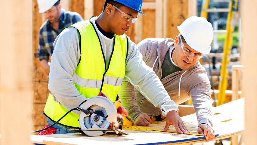 two workers looking at construction drawings